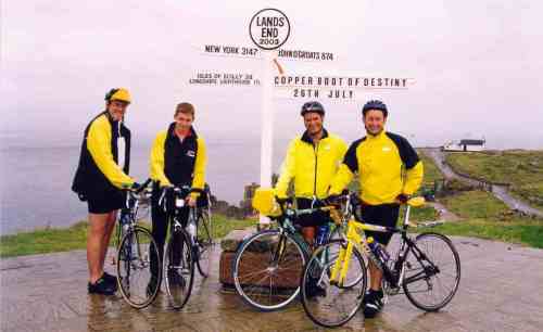 Posing at the Lands End signpost at the start of our Lands End to John O'Groats cycle